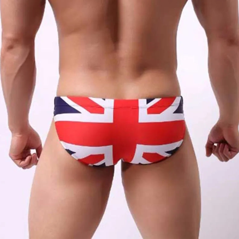 a sexy man in UK flag Men’s World Tour Bikini Swim Briefs - pridevoyageshop.com - gay men’s sexy swim briefs, trunks, board shorts, and bikinis