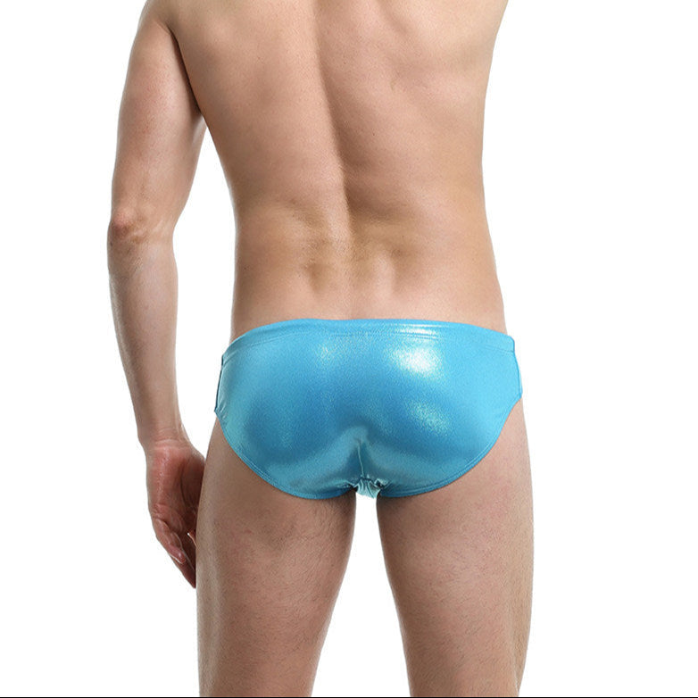 a sexy man in a sexy man in blue Men’s Slay the Shine Shiny Swim Briefs - pridevoyageshop.com - gay men’s sexy swim briefs, trunks, board shorts, and bikinis