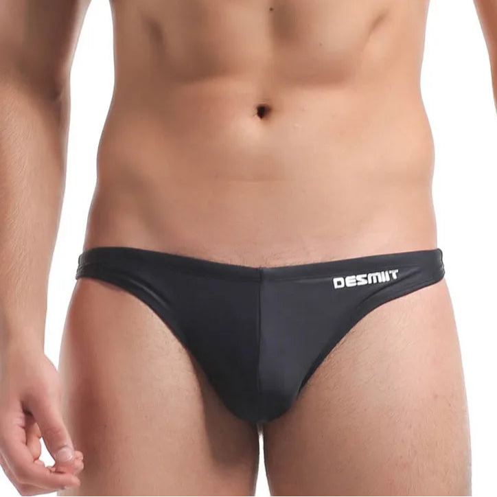 a sexy man in black DESMIIT Men’s Candy Drop Micro Bikini Swim Briefs - pridevoyageshop.com - gay men’s sexy swim briefs, trunks, board shorts, and bikinis

