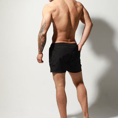 a sexy man in black Desmiit Men’s Circuit Signal Swim Short – pridevoyageshop.com – gay men’s sexy swim briefs, trunks, board shorts, and bikinis