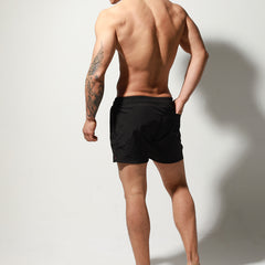 a sexy man in black Desmiit Men’s Circuit Signal Swim Short – pridevoyageshop.com – gay men’s sexy swim briefs, trunks, board shorts, and bikinis