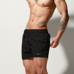a sexy man in black Desmiit Men’s Circuit Signal Swim Short – pridevoyageshop.com – gay men’s sexy swim briefs, trunks, board shorts, and bikinis