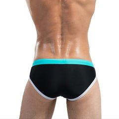 a sexy man in black Desmiit Men’s Colorblock Speed Bulge Swim Briefs - pridevoyageshop.com - gay men’s sexy swim briefs, trunks, board shorts, and bikinis