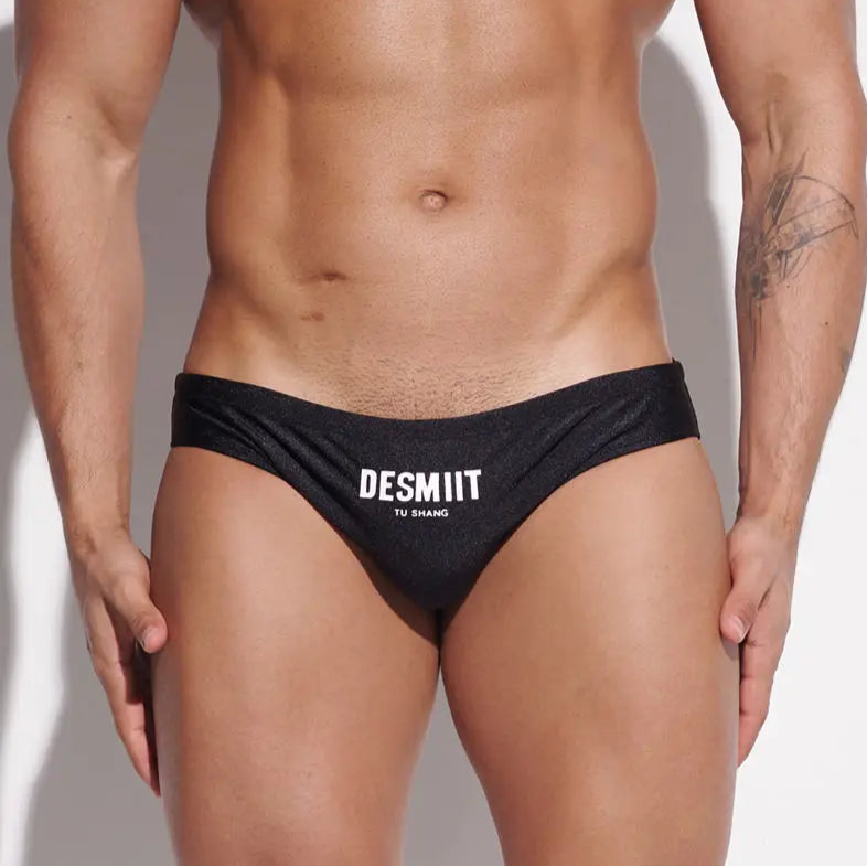 a sexy man in black Desmiit Men’s Sleek Statement Swim Briefs - pridevoyageshop.com - gay men’s sexy swim briefs, trunks, board shorts, and bikinis