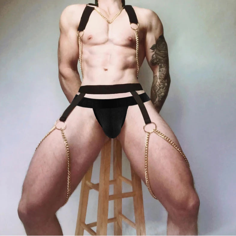 a sexy man in black Men’s After Dark Gold-Chain Harness & Garter Set – pridevoyageshop.com – gay men’s harness, lingerie and fetish wear
