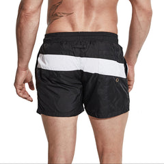 a sexy man in black Men’s Block Party Volley Swim Short – pridevoyageshop.com – gay men’s sexy swim briefs, trunks, board shorts, and bikinis