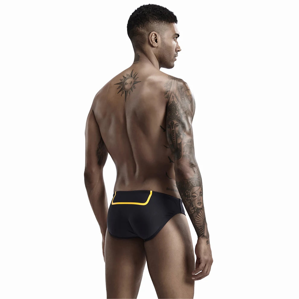 a sexy man in black Men’s Bold Bulge Wave Swim Briefs - pridevoyageshop.com - gay men’s sexy swim briefs, trunks, board shorts, and bikinis