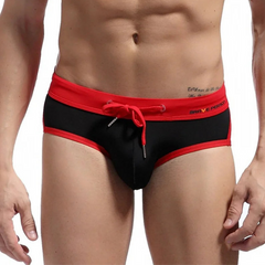 a sexy man in black Men’s Brave Package Swim Briefs - pridevoyageshop.com - gay men’s sexy swim briefs, trunks, board shorts, and bikinis