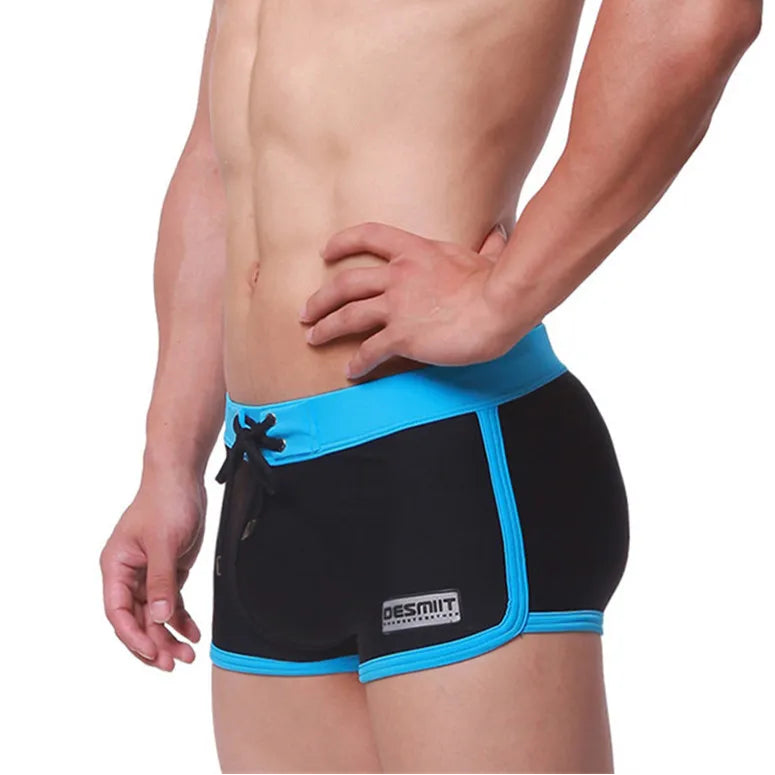 a sexy man in black Men’s Circuit Beat Low Rise Swim Trunks - pridevoyageshop.com - gay men’s sexy swim briefs, trunks, board shorts, and bikinis