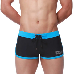 a sexy man in black Men’s Circuit Beat Low Rise Swim Trunks - pridevoyageshop.com - gay men’s sexy swim briefs, trunks, board shorts, and bikinis
