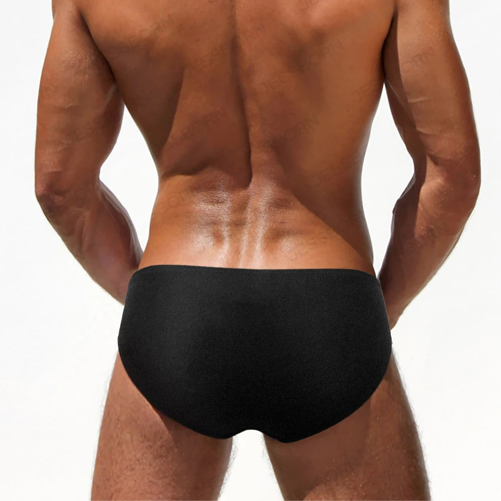 a sexy man in black Men’s Climax Buckle Bulge Swim Briefs - pridevoyageshop.com - gay men’s sexy swim briefs, trunks, board shorts, and bikinis
