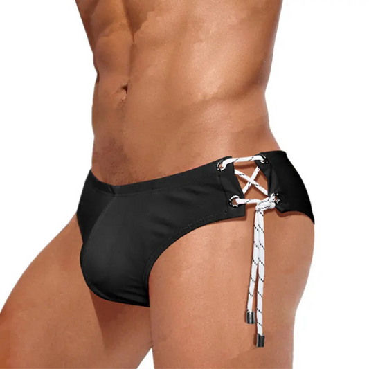 a sexy man in black Men's Flesh and Summer Side Tether Swim Brief - pridevoyageshop.com - gay men’s sexy swim briefs, trunks, board shorts, and bikinis