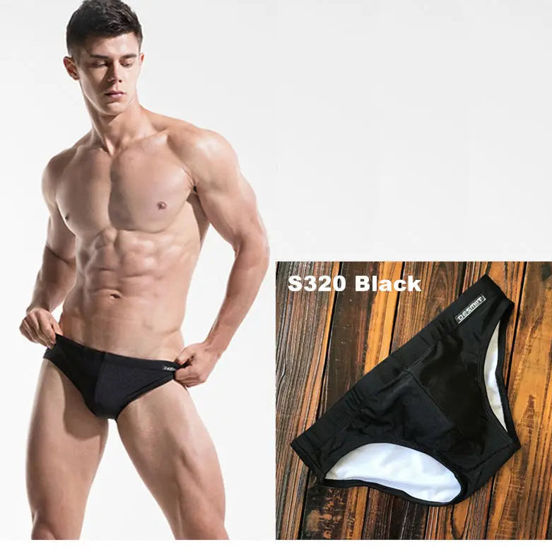 a sexy man in black Men’s Pool Plumper Padded Swim Briefs - pridevoyageshop.com - gay men’s sexy swim briefs, trunks, board shorts, and bikinis