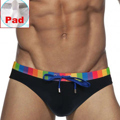 a sexy man in black Men’s Pride Patrol Rainbow Band Swim Briefs with pad - pridevoyageshop.com - gay men’s sexy swim briefs, trunks, board shorts, and bikinis