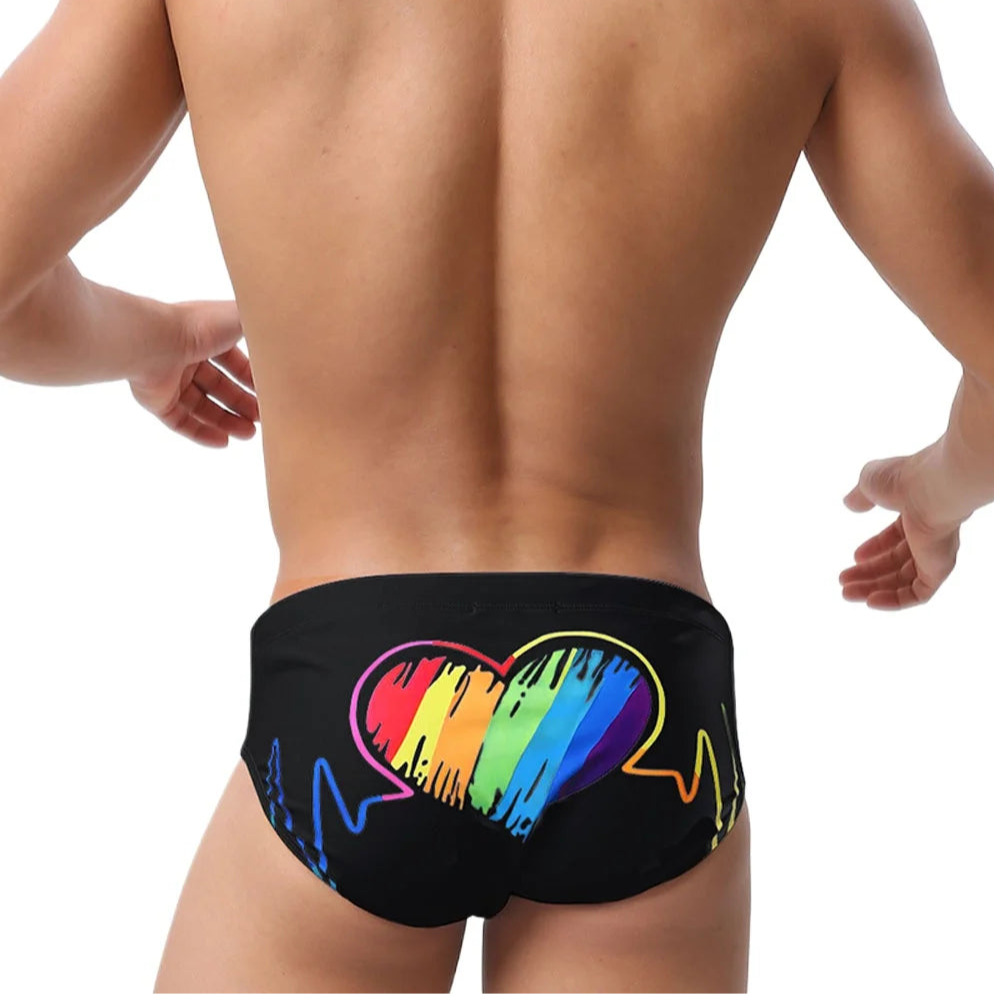 a sexy man in black Men’s Rainbow Heartbeat Swim Briefs - pridevoyageshop.com - gay men’s sexy swim briefs, trunks, board shorts, and bikinis