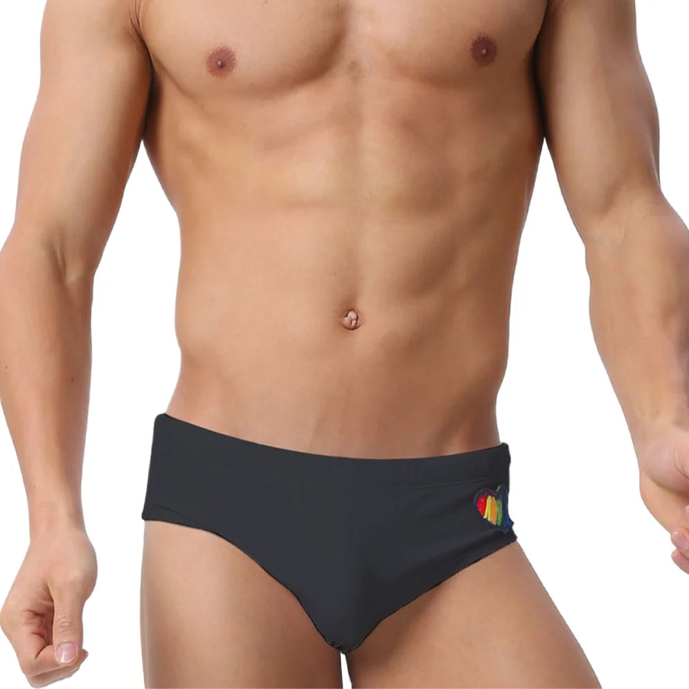 a sexy man in black Men’s Rainbow Heartbeat Swim Briefs - pridevoyageshop.com - gay men’s sexy swim briefs, trunks, board shorts, and bikinis