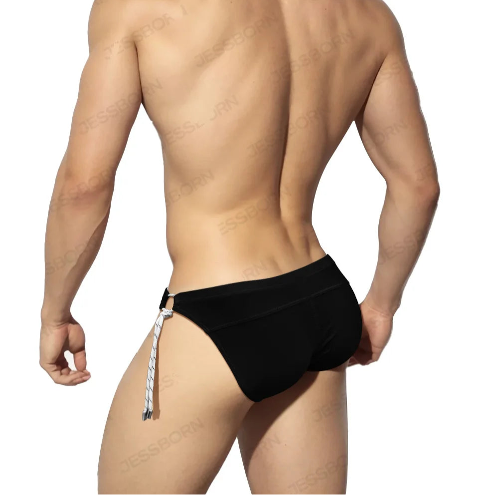 a sexy man in black Men's Rope Me Up Side Tether Swim Briefs - pridevoyageshop.com - gay men’s sexy swim briefs, trunks, board shorts, and bikinis