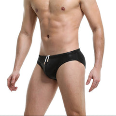a sexy man in black Men’s Slay the Shine Shiny Swim Briefs - pridevoyageshop.com - gay men’s sexy swim briefs, trunks, board shorts, and bikinis