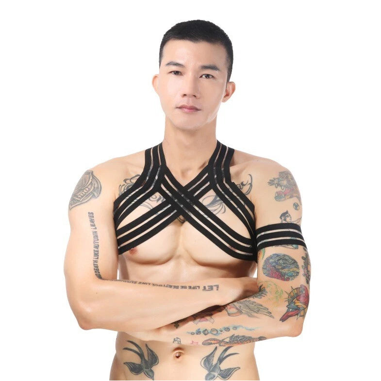 a sexy man in black Men’s The Lewk Chest Harness Set – pridevoyageshop.com – gay men’s harness, lingerie and fetish wear