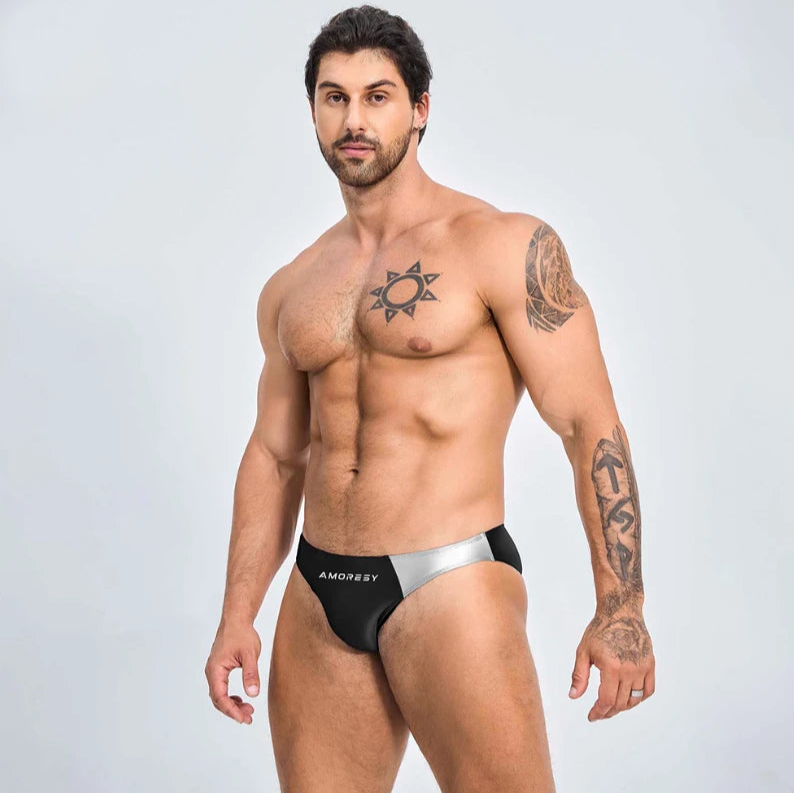 a sexy man in black Men’s Ultra-Slick Wet Werk Mini Swim Briefs - pridevoyageshop.com - gay men’s sexy swim briefs, trunks, board shorts, and bikinis