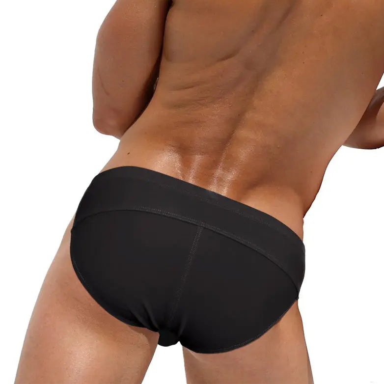 a sexy man in black Men’s Unclip Me Double Buckle Swim Briefs - pridevoyageshop.com - gay men’s sexy swim briefs, trunks, board shorts, and bikinis