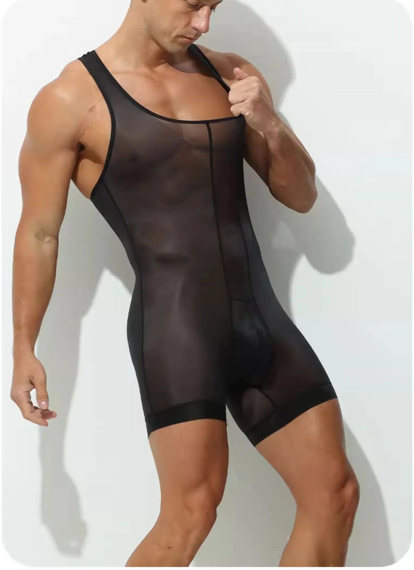 a sexy man in black Uncensored Sheer-Stripe Singlet, transparent stripe mesh body paneling, erotic tight fit, seductive fetish athletic vibe – pridevoyageshop.com – gay men’s harness, lingerie and fetish wear