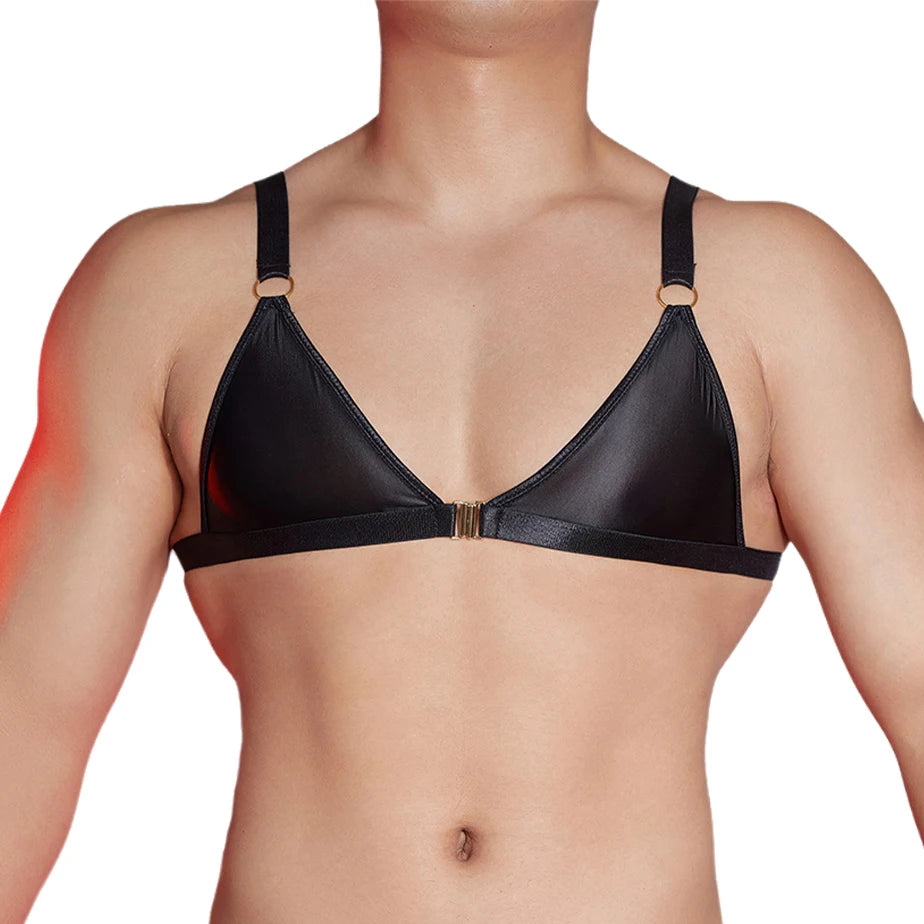 a sexy man in black faux-leather bralette with front clasp, shiny finish hugging chest and showing pecs and straps – pridevoyageshop.com – gay men’s harness, lingerie and fetish wear
