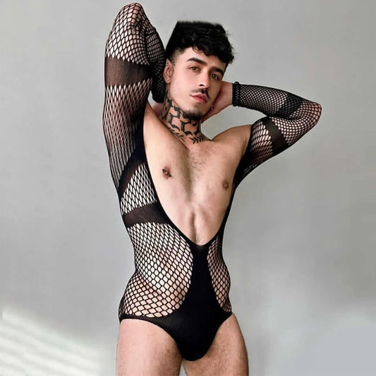 a sexy man in black fishnet teddy with open chest and thong cut showing bold dual-mood aesthetic – pridevoyageshop.com – gay men’s harness, lingerie and fetish wear
