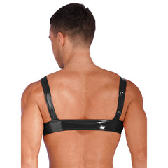 a sexy man in black high-shine vinyl harness with bold chest straps and metal buckles – pridevoyageshop.com – gay men’s harness, lingerie and fetish wear