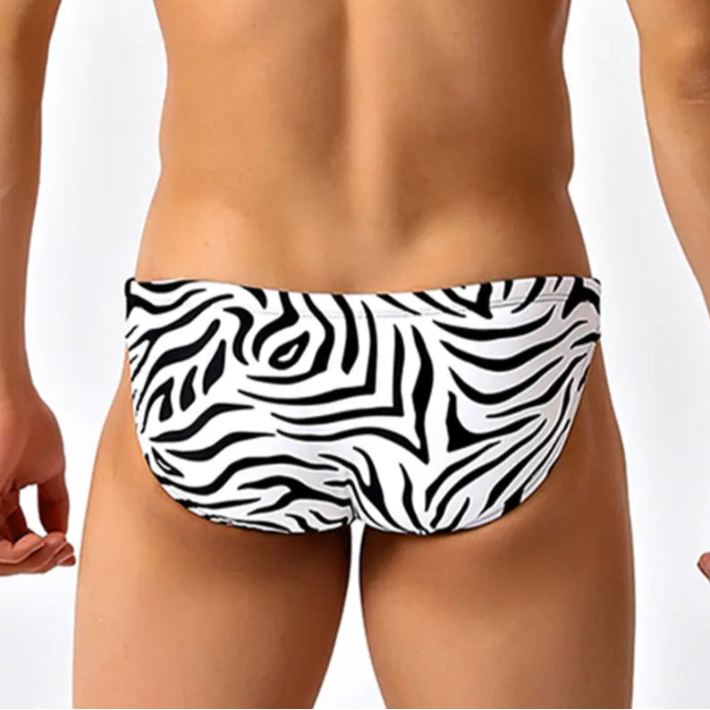 a sexy man in black striped Men’s Wild Streak Swim Briefs - pridevoyageshop.com - gay men’s sexy swim briefs, trunks, board shorts, and bikinis