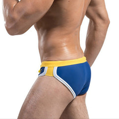 a sexy man in blue Desmiit Men’s Colorblock Speed Bulge Swim Briefs - pridevoyageshop.com - gay men’s sexy swim briefs, trunks, board shorts, and bikinis