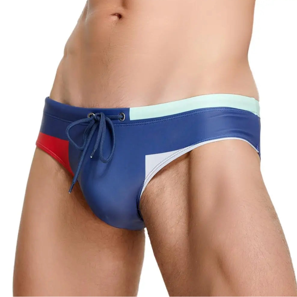 a sexy man in blue Men’s Colorblock Bait Swim Briefs - pridevoyageshop.com - gay men’s sexy swim briefs, trunks, board shorts, and bikinis
