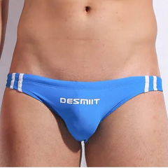 a sexy man in blue Men’s Fast & Curious Skinny Swim Briefs - pridevoyageshop.com - gay men’s sexy swim briefs, trunks, board shorts, and bikinis