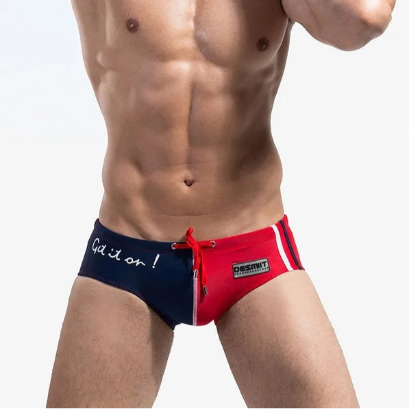 a sexy man in blue and red Desmiit Men’s Game On! Low Rise Swim Trunks - pridevoyageshop.com - gay men’s sexy swim briefs, trunks, board shorts, and bikinis