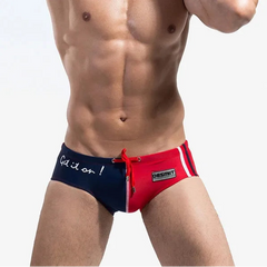 a sexy man in blue and red Desmiit Men’s Game On! Low Rise Swim Trunks - pridevoyageshop.com - gay men’s sexy swim briefs, trunks, board shorts, and bikinis
