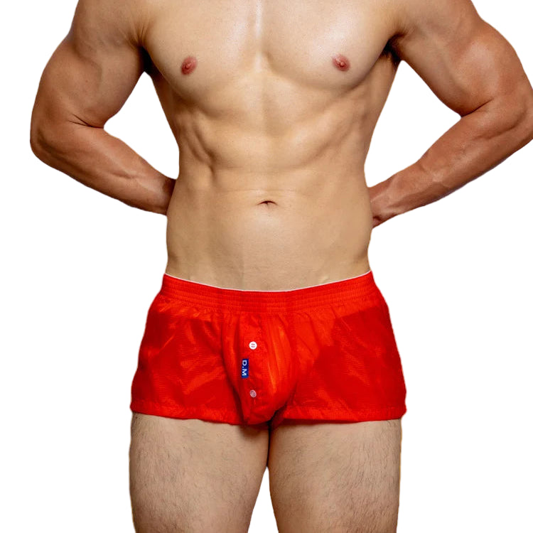 a sexy man in coral red DM Men’s Airdrop Low-Rise Sheer Boxers – pridevoyageshop.com – gay men’s sexy swim briefs, trunks, board shorts, and bikinis