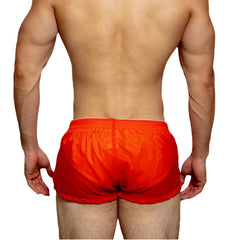 a sexy man in coral red DM Men’s Airdrop Low-Rise Sheer Boxers – pridevoyageshop.com – gay men’s sexy swim briefs, trunks, board shorts, and bikinis