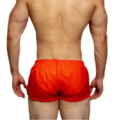 a sexy man in coral red DM Men’s Airdrop Low-Rise Sheer Boxers – pridevoyageshop.com – gay men’s sexy swim briefs, trunks, board shorts, and bikinis