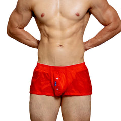 a sexy man in coral red DM Men’s Airdrop Low-Rise Sheer Boxers – pridevoyageshop.com – gay men’s sexy swim briefs, trunks, board shorts, and bikinis