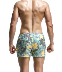 a sexy man in cyan blue Men’s Tap-Ready Tides Swim Beach Surf Shorts – pridevoyageshop.com – gay men’s sexy swim briefs, trunks, board shorts, and bikinis
