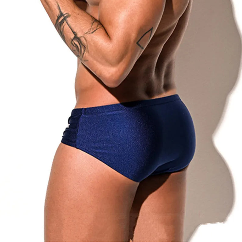 a sexy man in dark blue Desmiit Men’s Pouch Devil Low Rise Swim Briefs - pridevoyageshop.com - gay men’s sexy swim briefs, trunks, board shorts, and bikinis
