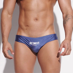 a sexy man in dark blue Desmiit Men’s Sleek Statement Swim Briefs - pridevoyageshop.com - gay men’s sexy swim briefs, trunks, board shorts, and bikinis