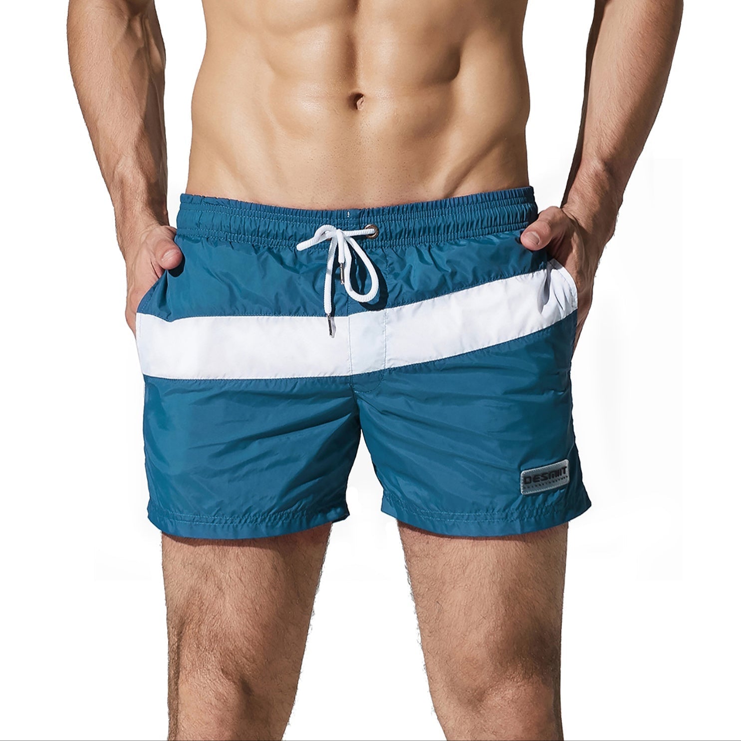 a sexy man in dark blue Men’s Block Party Volley Swim Short – pridevoyageshop.com – gay men’s sexy swim briefs, trunks, board shorts, and bikinis
