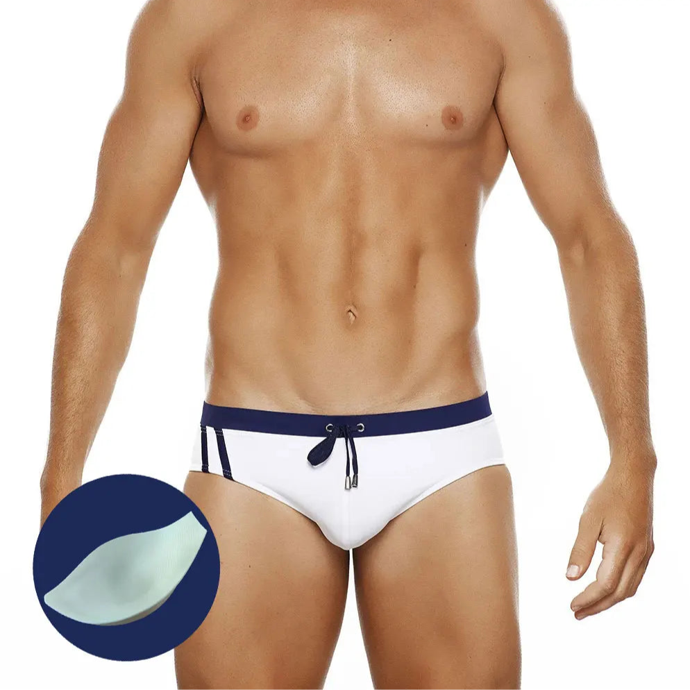a sexy man in dark blue Men’s Clean Line Hookup Swim Briefs with pad - pridevoyageshop.com - gay men’s sexy swim briefs, trunks, board shorts, and bikinis