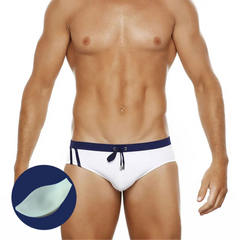 a sexy man in dark blue Men’s Clean Line Hookup Swim Briefs with pad - pridevoyageshop.com - gay men’s sexy swim briefs, trunks, board shorts, and bikinis