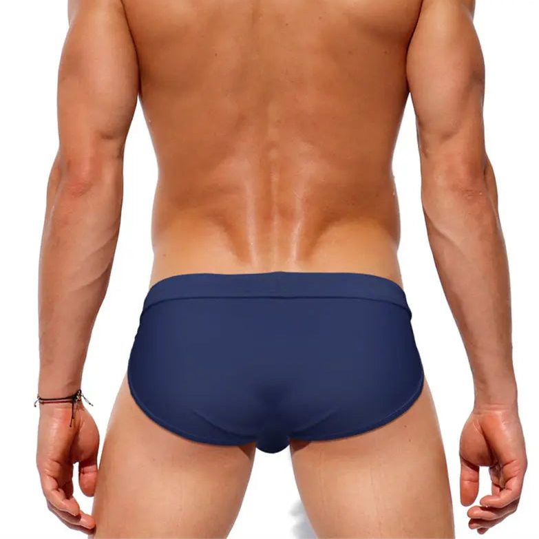 a sexy man in dark blue Men’s Clean Slate Swim Briefs - pridevoyageshop.com - gay men’s sexy swim briefs, trunks, board shorts, and bikinis