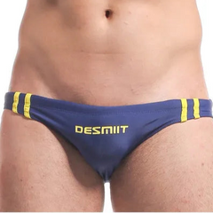 a sexy man in dark blue Men’s Fast & Curious Skinny Swim Briefs - pridevoyageshop.com - gay men’s sexy swim briefs, trunks, board shorts, and bikinis