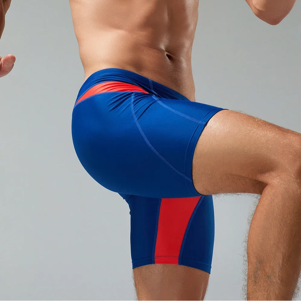 a sexy man in dark blue Men’s Iron Vortex Compression Swim Shorts – pridevoyageshop.com – gay men’s sexy swim briefs, trunks, board shorts, and bikinis