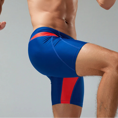 a sexy man in dark blue Men’s Iron Vortex Compression Swim Shorts – pridevoyageshop.com – gay men’s sexy swim briefs, trunks, board shorts, and bikinis