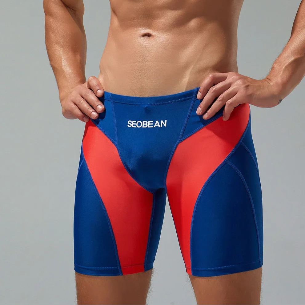 a sexy man in dark blue Men’s Iron Vortex Compression Swim Shorts – pridevoyageshop.com – gay men’s sexy swim briefs, trunks, board shorts, and bikinis